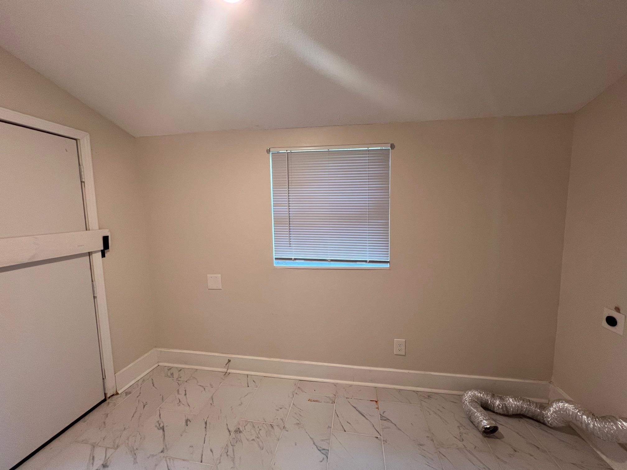 734 Spring Street Memphis, TN 38112 - Photo 5 of 13 an empty room with a workbench
