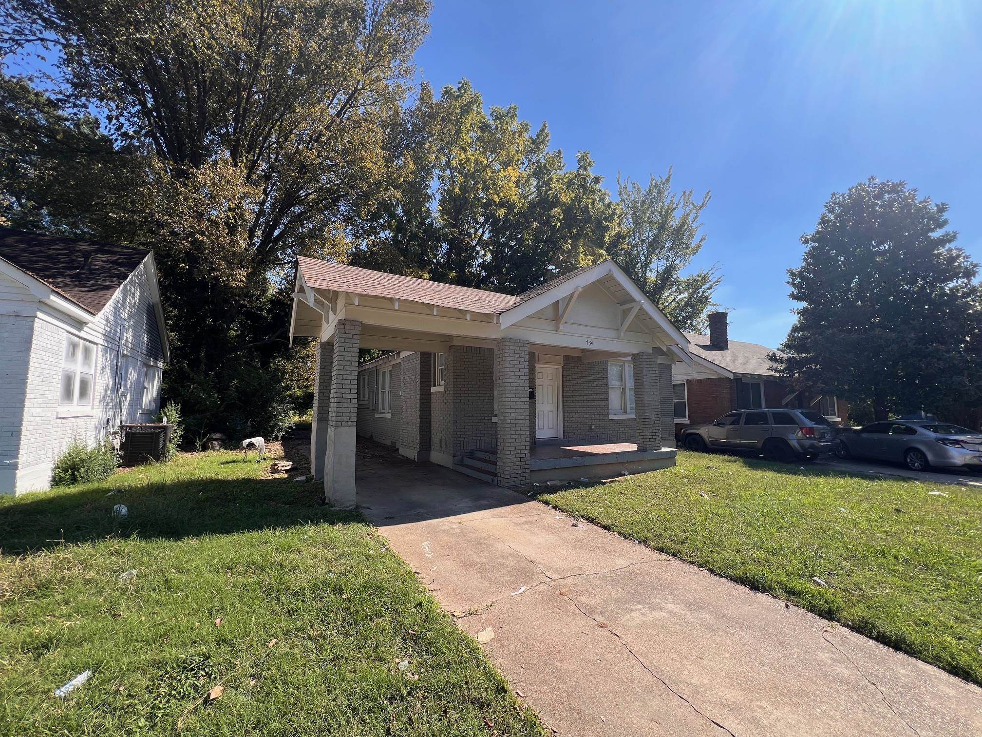 734 Spring Street Memphis, TN 38112 - Photo 8 of 13 a front view of a house with a yard and garage