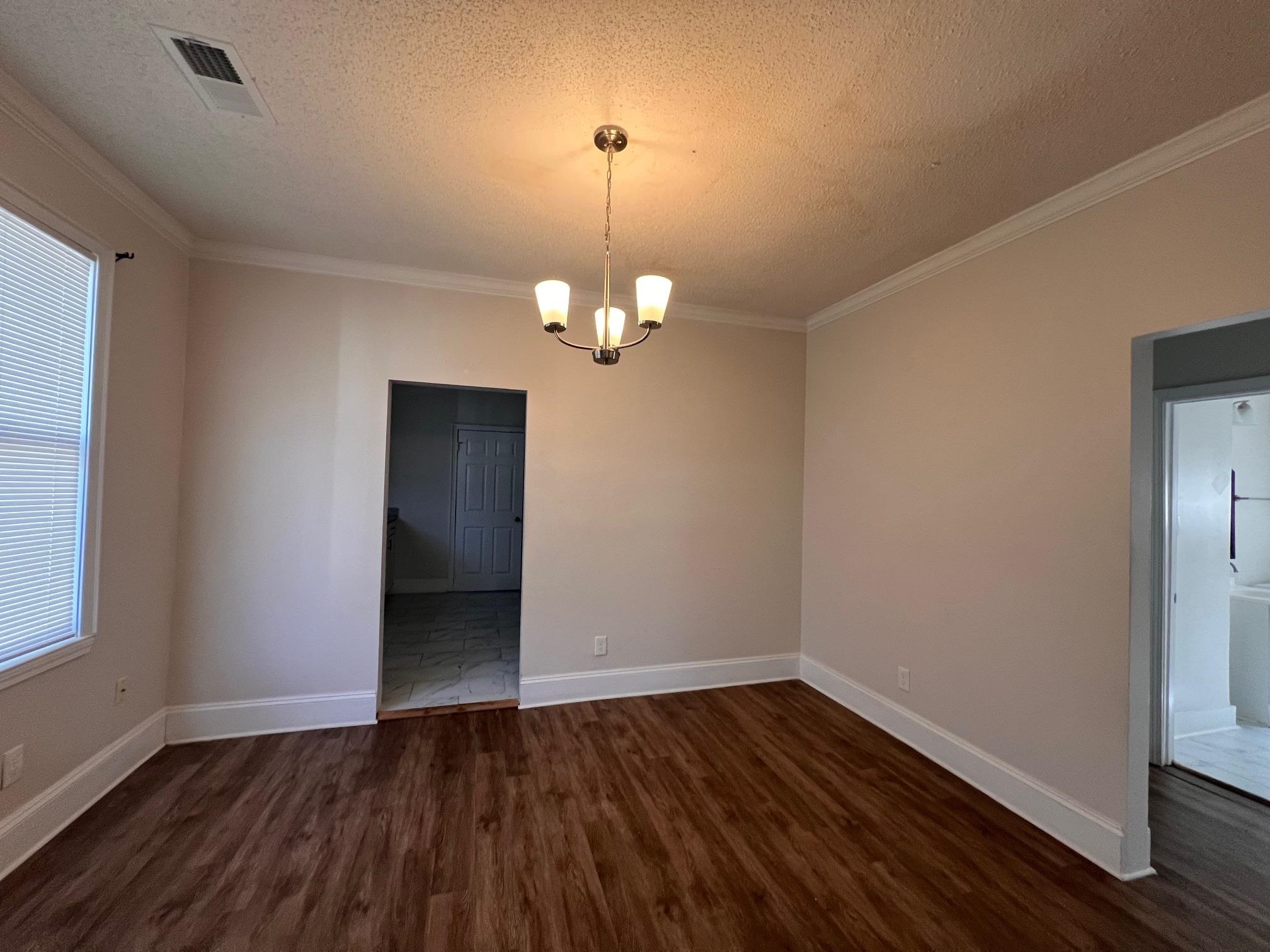 734 Spring Street Memphis, TN 38112 - Photo 9 of 13 an empty room with wooden floor and windows