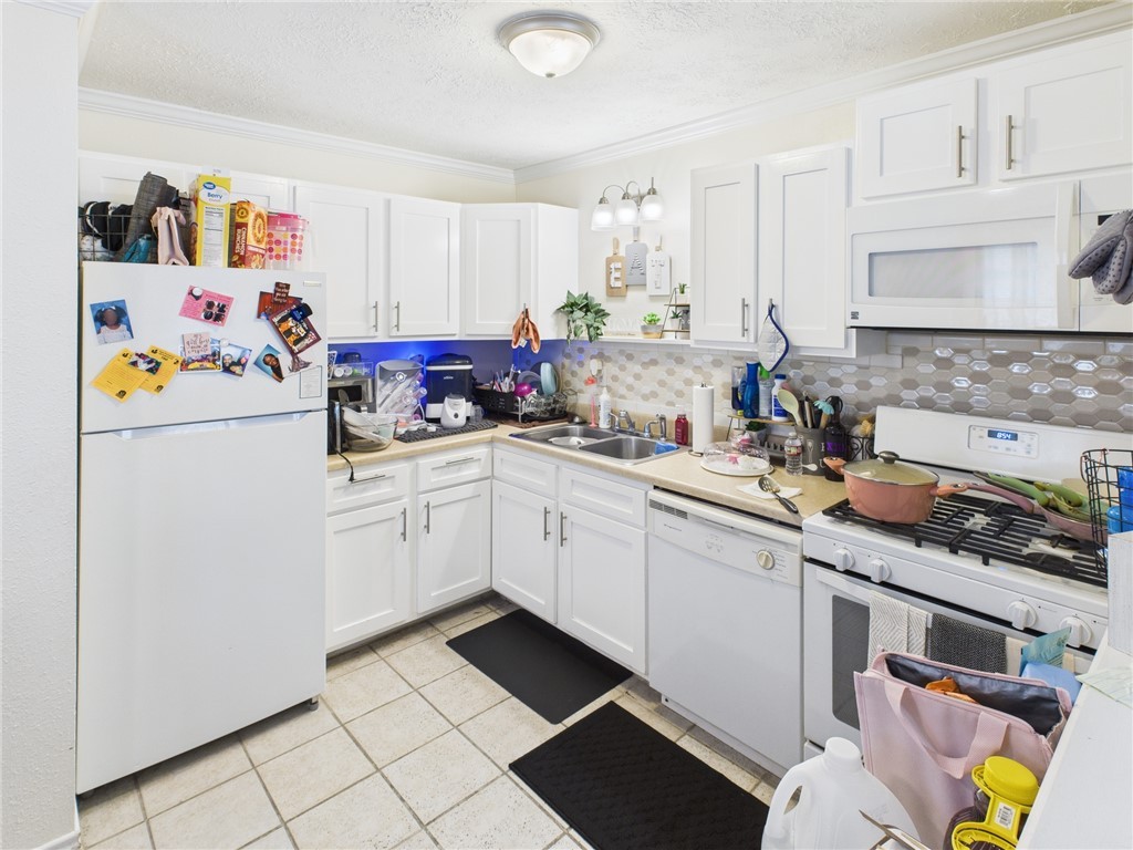 3304 Longleaf Circle College Station, TX 77845 - Photo 2 of 8 a kitchen with a refrigerator and a sink