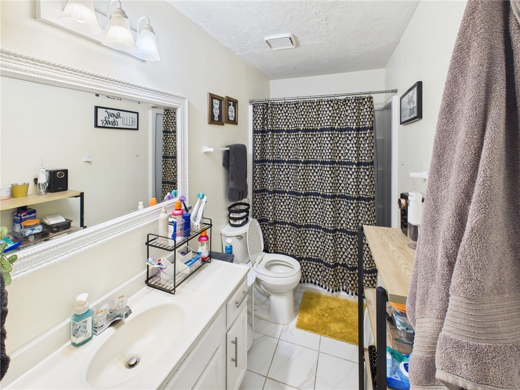 3304 Longleaf Circle College Station, TX 77845 - Photo 6 of 8 a bathroom with a sink toilet and shower