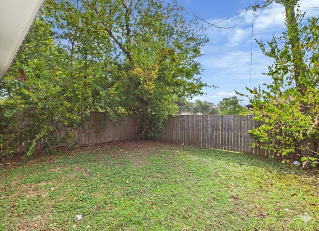 3304 Longleaf Circle College Station, TX 77845 - Photo 8 of 8 a view of a backyard with plants and wooden fence