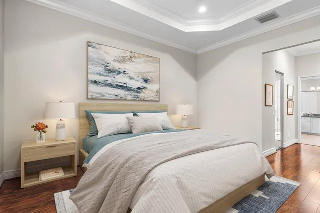 a bedroom with bed and a painting on the wall