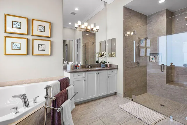 a bathroom with a sink mirror and a shower