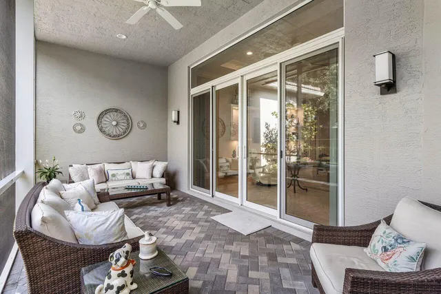 a view of a backyard with table and chairs and large tree