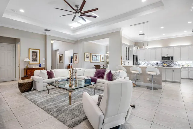 a living room with lots of furniture and view of kitchen