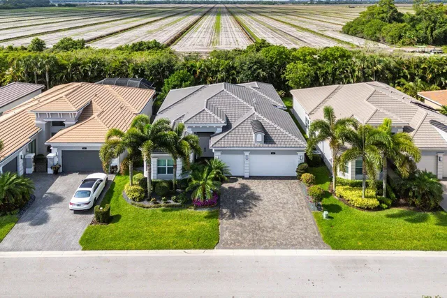 a front view of a house with a fountain