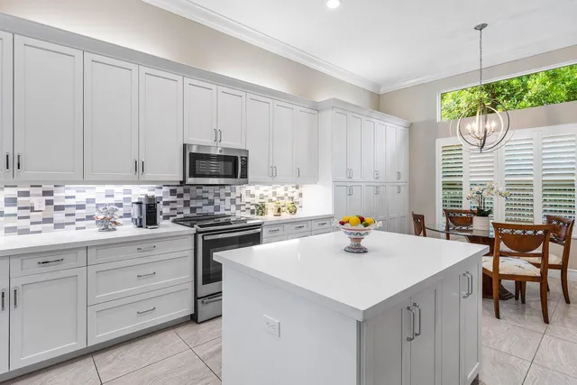 a kitchen with a sink cabinets and wooden floor