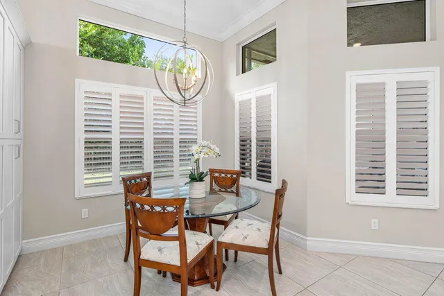 a view of a dining room with furniture and a window
