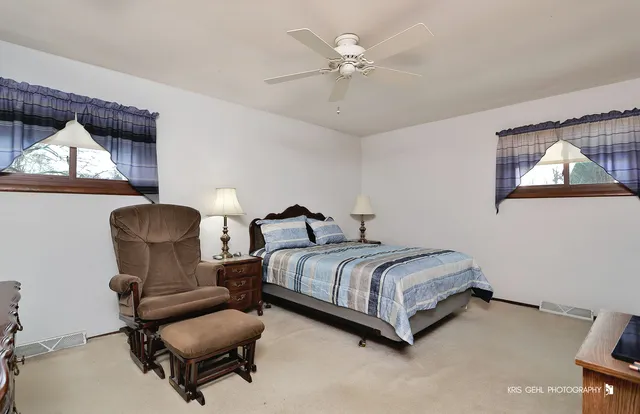 a room with a bed and a painting on the wall