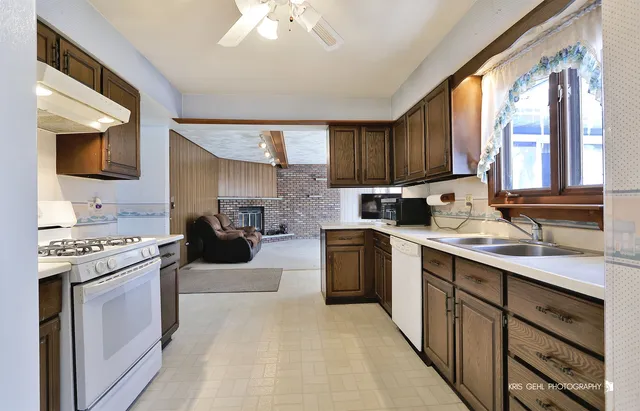 a kitchen with a sink stove and cabinets