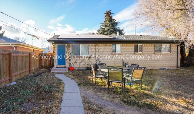 a view of a house with backyard and sitting area