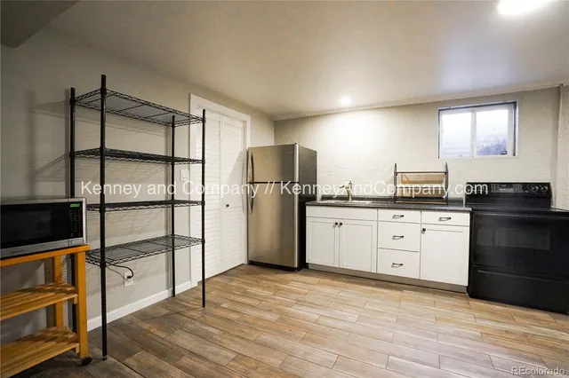 a kitchen with stainless steel appliances a refrigerator sink and cabinets