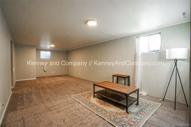 an empty room with closet and a chandelier fan