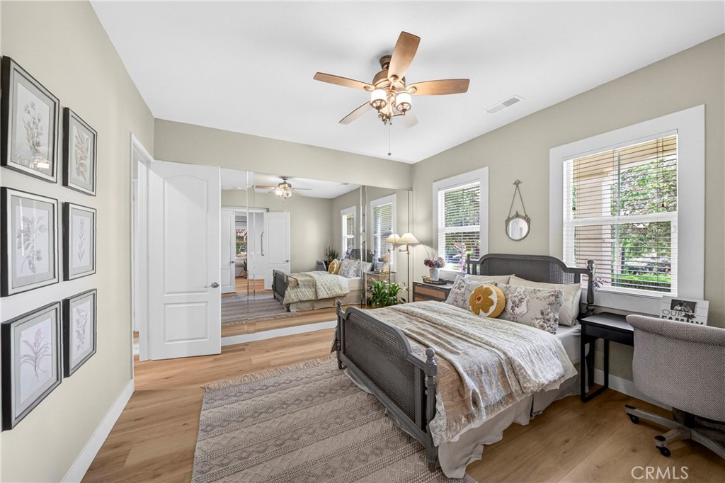 16375 Ory Circle Riverside, CA 92503 - Photo 21 of 51 a spacious bedroom with a large bed a chandelier and windows