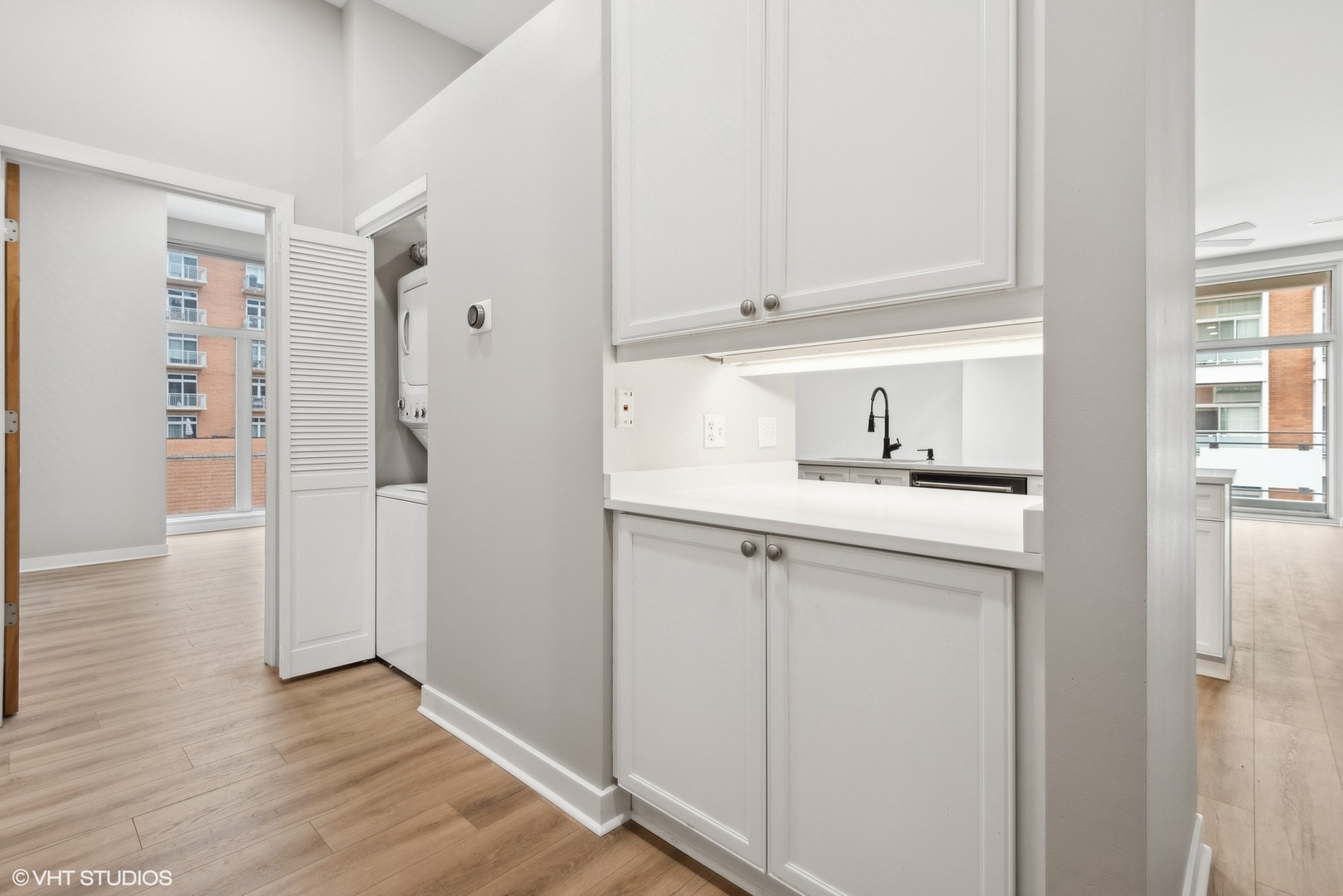 939 West Madison Street, Unit 410 Chicago, IL 60607 - Photo 11 of 23 a kitchen with a refrigerator and cabinets