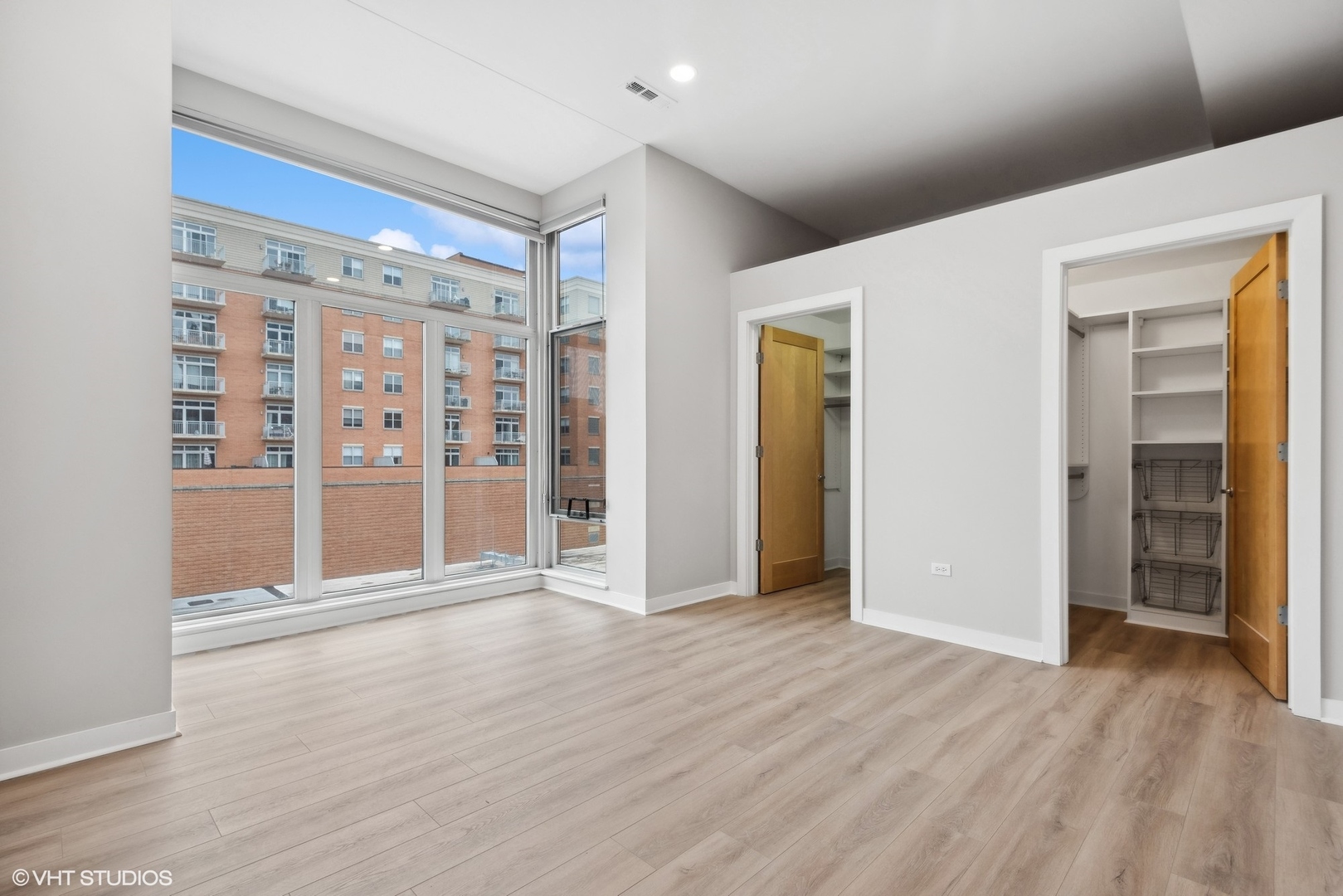 939 West Madison Street, Unit 410 Chicago, IL 60607 - Photo 12 of 23 a view of an empty room with wooden floor and entryway