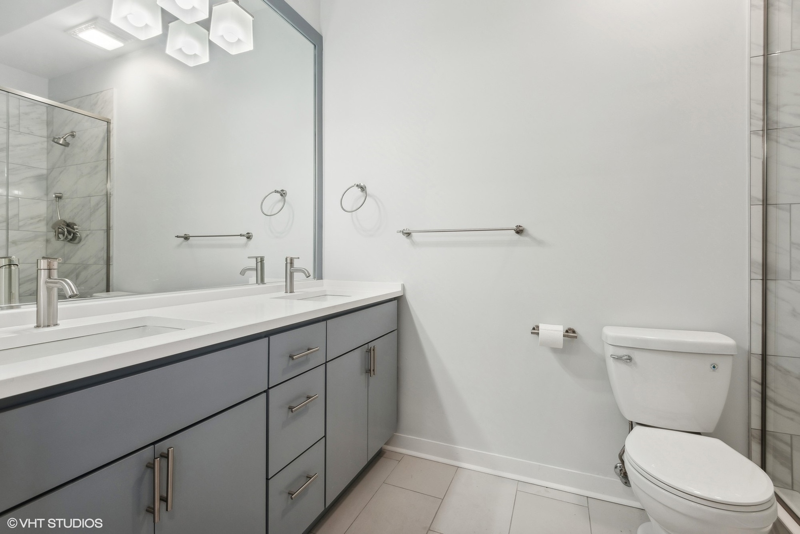 939 West Madison Street, Unit 410 Chicago, IL 60607 - Photo 14 of 23 a bathroom with a granite countertop sink a toilet and a mirror