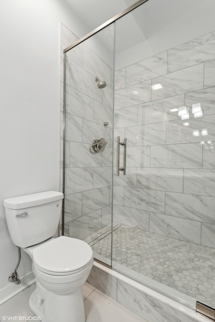 939 West Madison Street, Unit 410 Chicago, IL 60607 - Photo 15 of 23 a bathroom with a toilet and a shower