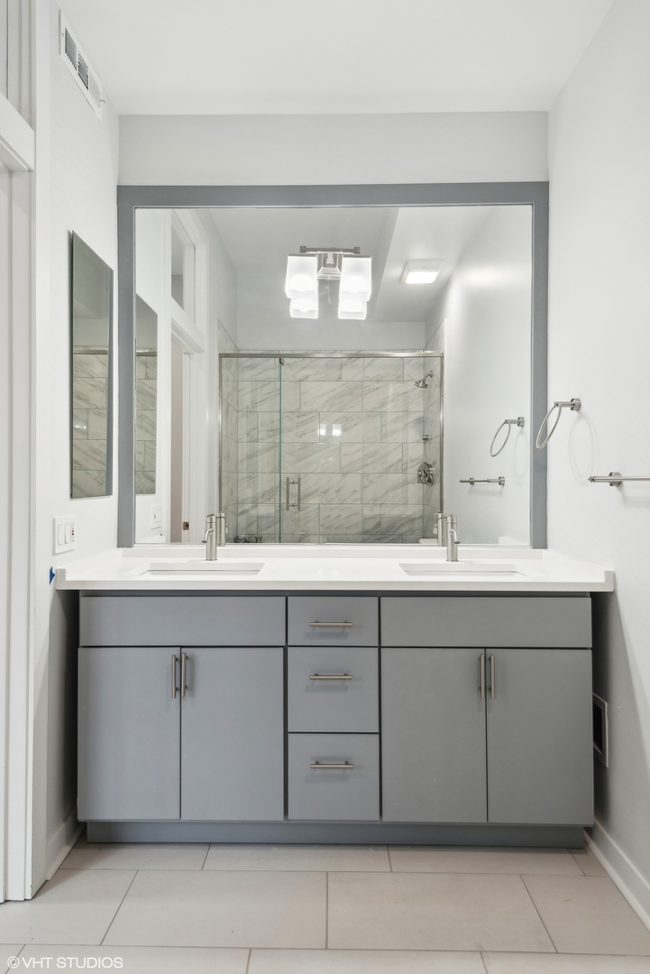 939 West Madison Street, Unit 410 Chicago, IL 60607 - Photo 17 of 23 a bathroom with a sink and a mirror