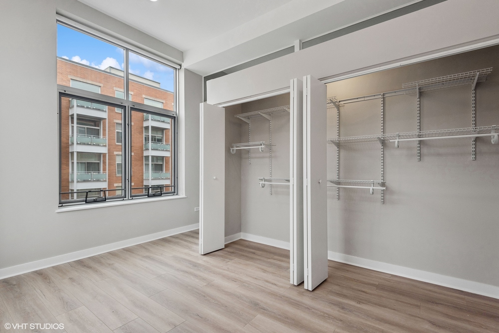 939 West Madison Street, Unit 410 Chicago, IL 60607 - Photo 19 of 23 a view of empty room with wooden floor and fan