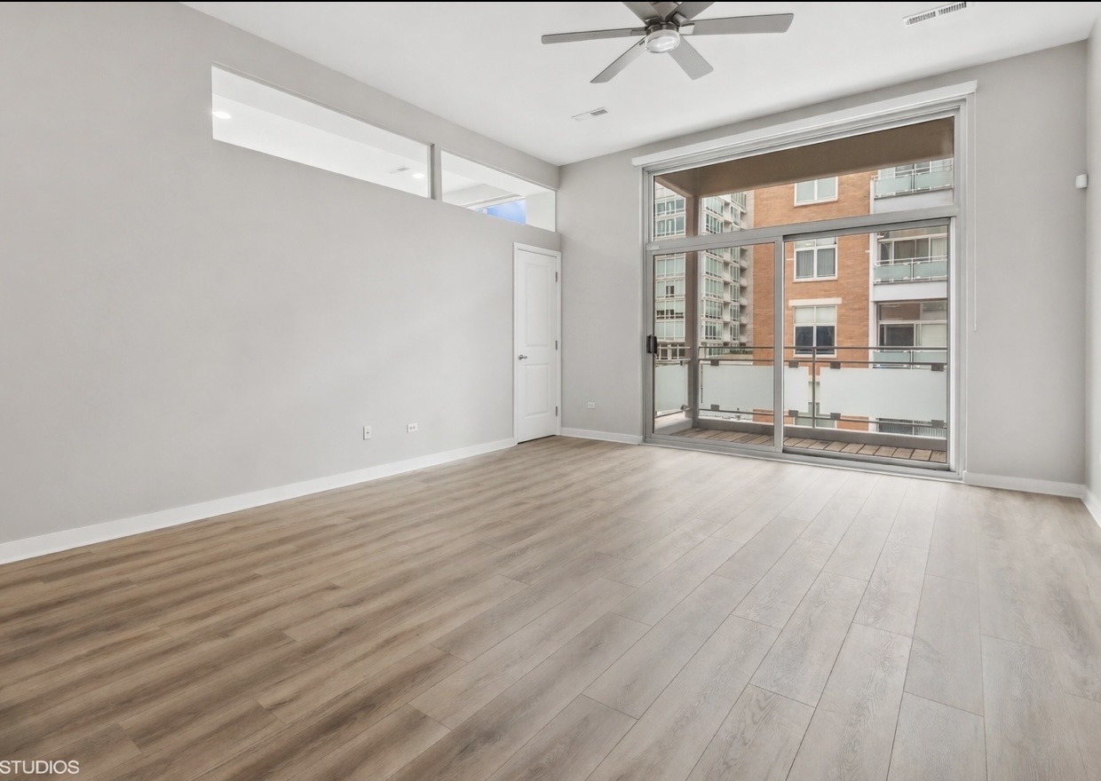 939 West Madison Street, Unit 410 Chicago, IL 60607 - Photo 3 of 23 wooden floor in an empty room with a window