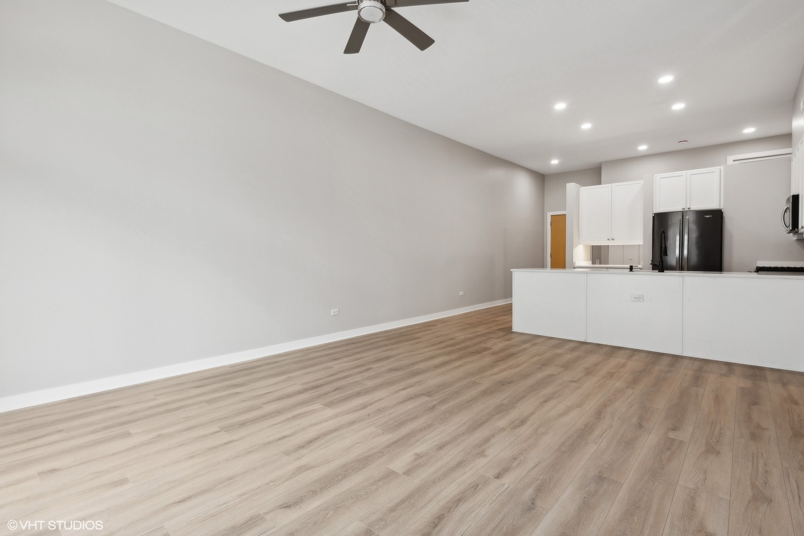 939 West Madison Street, Unit 410 Chicago, IL 60607 - Photo 4 of 23 a view of a kitchen with a sink and dishwasher with wooden floor
