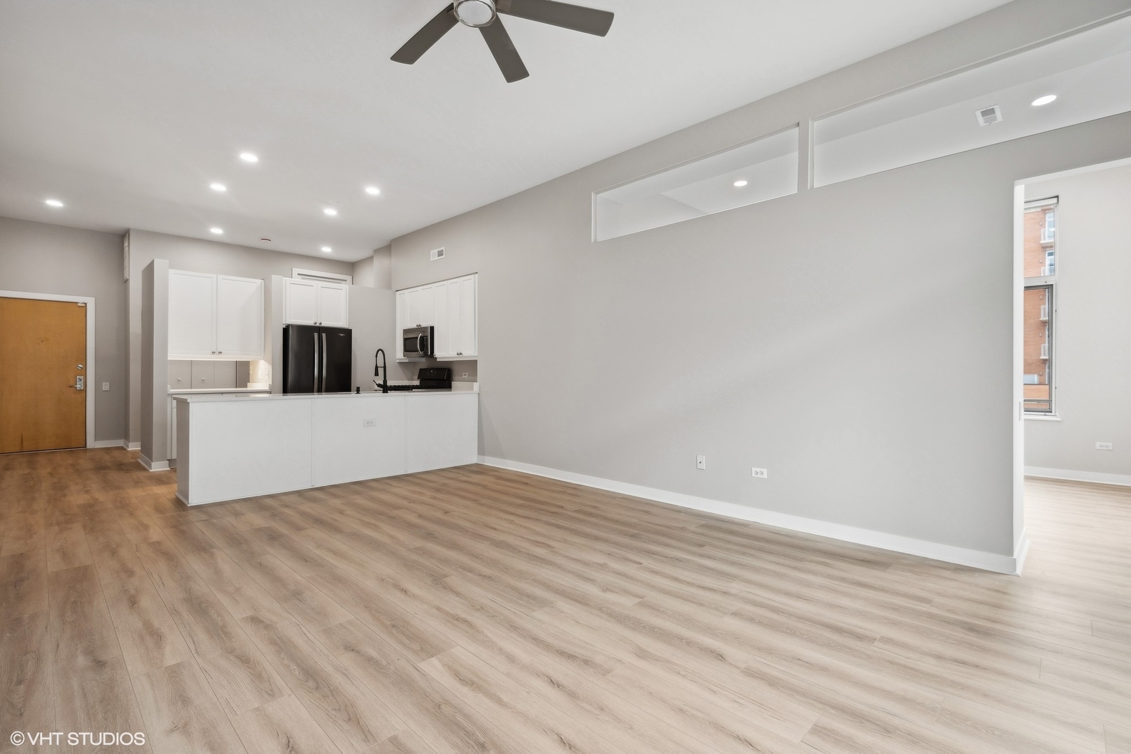 939 West Madison Street, Unit 410 Chicago, IL 60607 - Photo 5 of 23 a view of a kitchen with a sink and a refrigerator