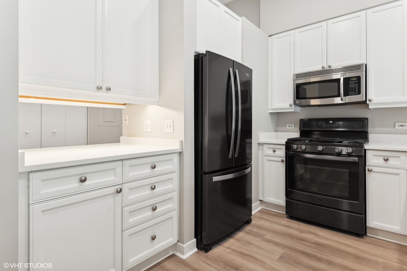 939 West Madison Street, Unit 410 Chicago, IL 60607 - Photo 9 of 23 a kitchen with white cabinets and stainless steel appliances