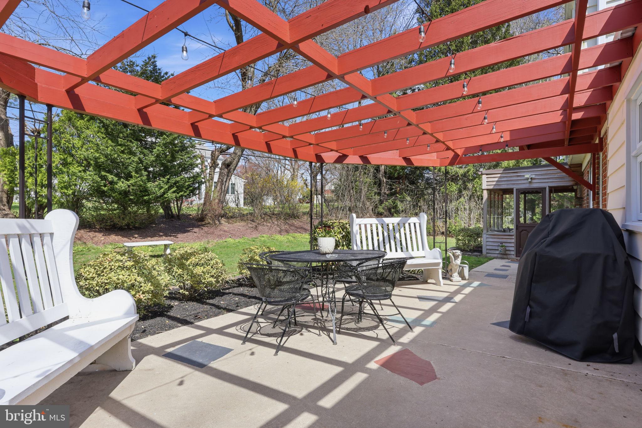 3868 Blake Road Huntingdon Valley, PA 19006 - Photo 36 of 50 a view of a patio with a table and chairs under an umbrella