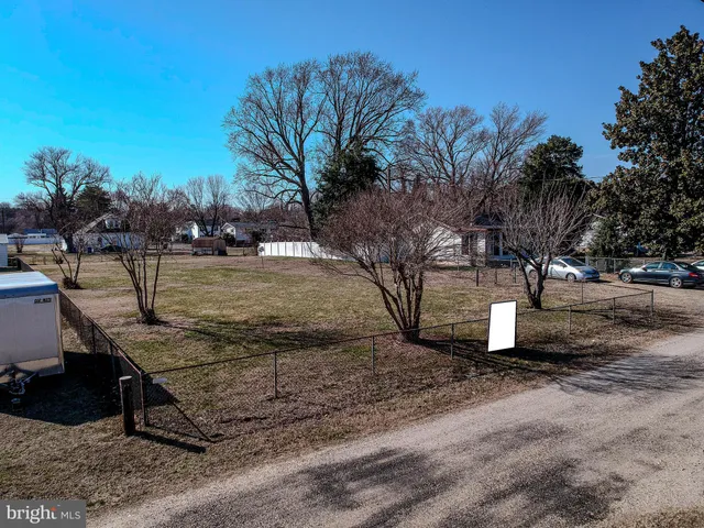 a backyard of a house with fire pit and outdoor seating