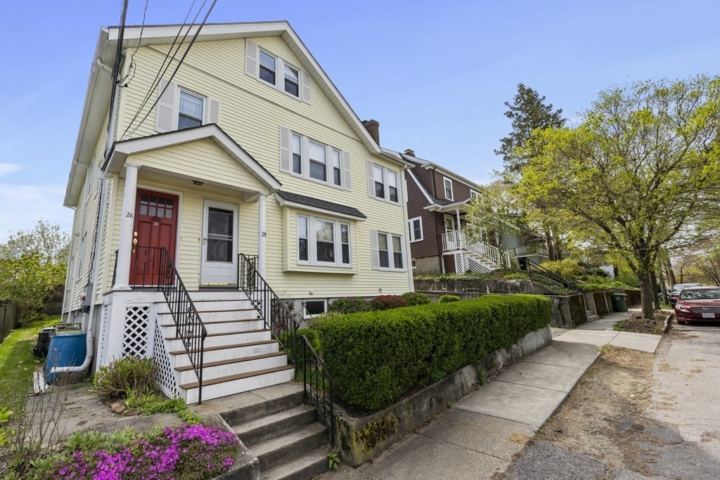 a front view of a house with a garden