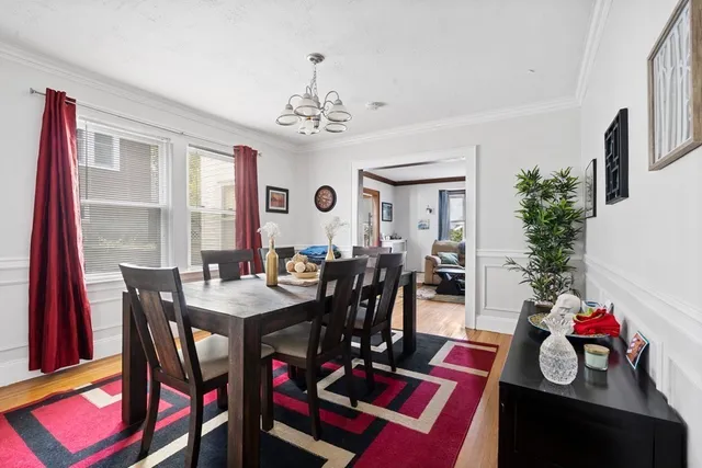 a view of a dining room with furniture and a chandelier