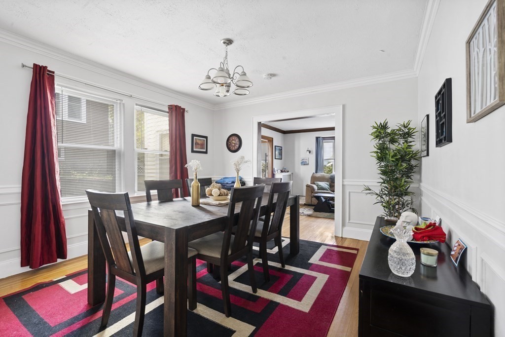 28 Warwick Road, Unit 1 Watertown, MA 02472 - Photo 5 of 12 a view of a dining room with furniture and a chandelier