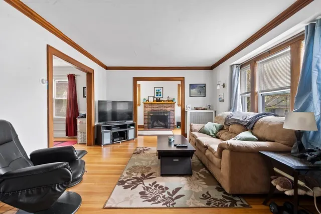 a living room with furniture large window and flat screen tv