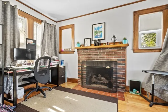 a view of a livingroom with workspace and a window