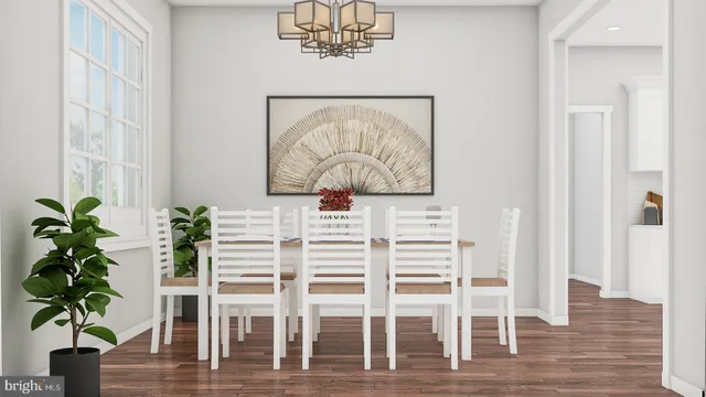 a view of a dining room with wooden floor and a potted plant