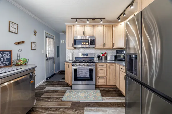 a kitchen with a refrigerator and a stove