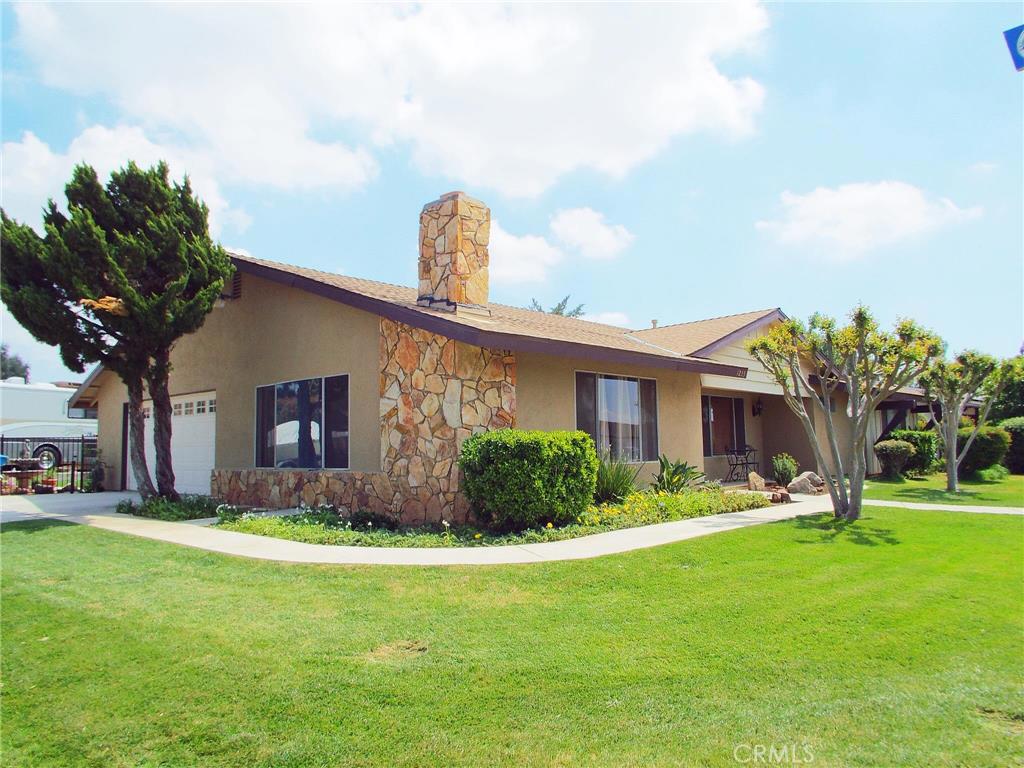 a front view of house with yard and green space
