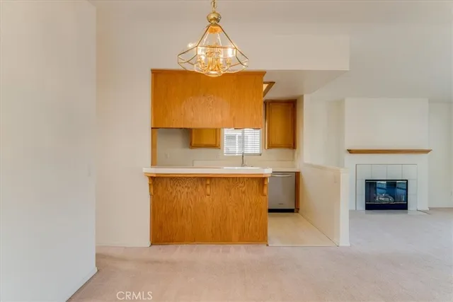 a view of kitchen with granite countertop cabinets and a fireplace