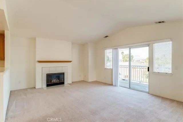 an empty room with furniture and a fireplace