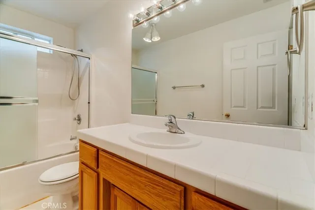 a bathroom with a sink toilet double vanity and shower