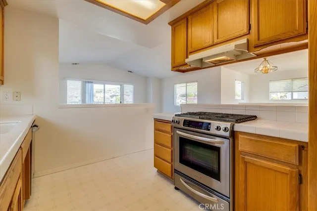 a kitchen with stainless steel appliances granite countertop a stove and a microwave
