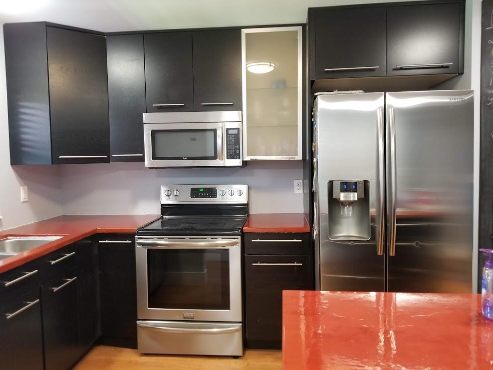 a kitchen with a refrigerator sink and microwave