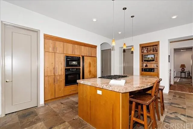 a kitchen with stainless steel appliances granite countertop furniture and stove