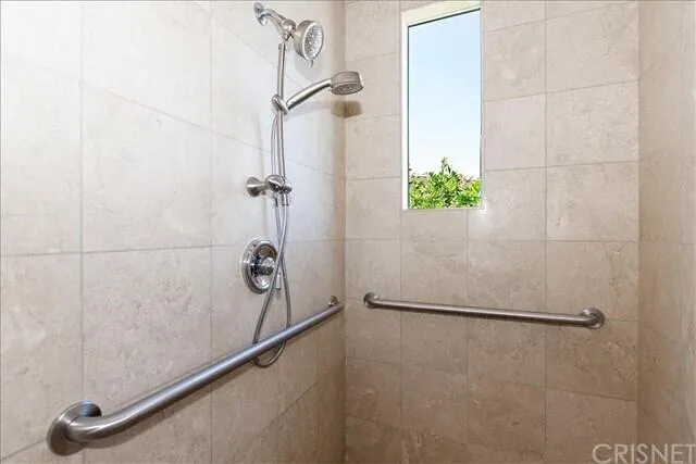 a bathroom with a double vanity sink a mirror and a bathtub