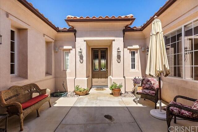 69707 Camino Pacifico Rancho Mirage, CA 92270 - Photo 2 of 38 a living room with furniture chess board and a fireplace