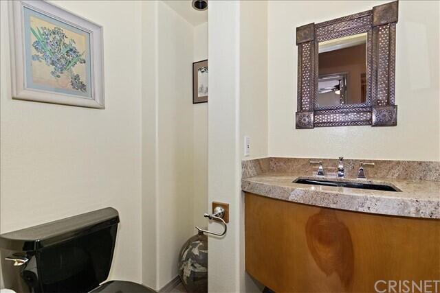 69707 Camino Pacifico Rancho Mirage, CA 92270 - Photo 22 of 38 a bathroom with a granite countertop sink and a mirror