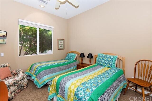 69707 Camino Pacifico Rancho Mirage, CA 92270 - Photo 23 of 38 a bedroom with two beds and a large window