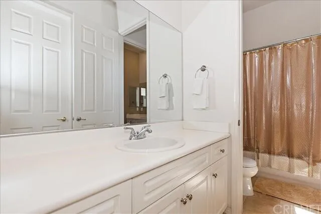 a bathroom with a shower curtain and a sink
